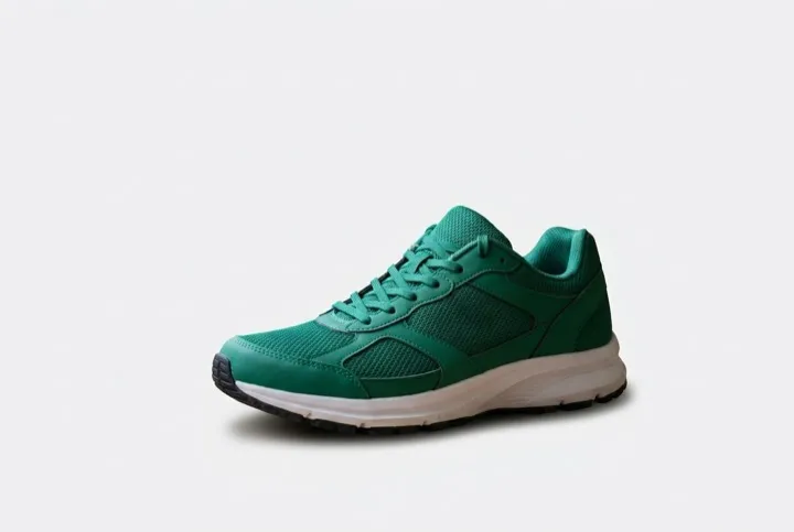 After: the same green running shoe, cut out and placed on a clean light-grey background.